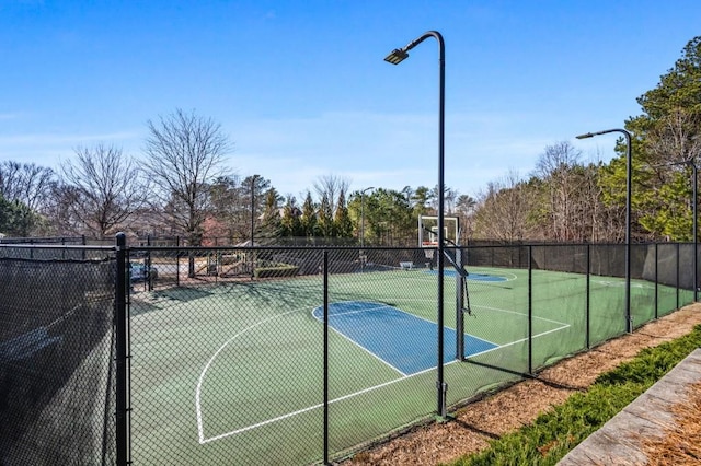 view of sport court with basketball hoop