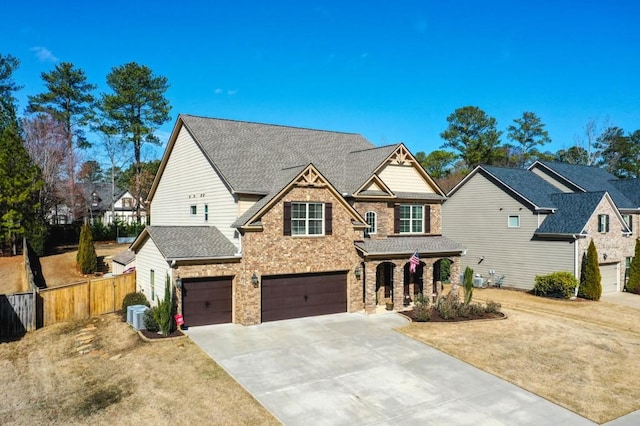 view of front of home featuring a garage, cooling unit, and a front lawn