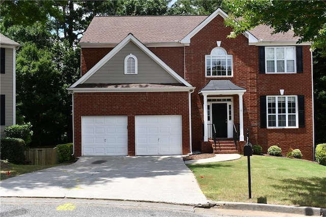 view of front of home featuring a front yard and a garage