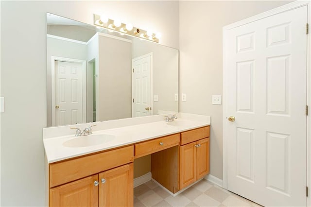 bathroom featuring tile floors, oversized vanity, crown molding, and dual sinks