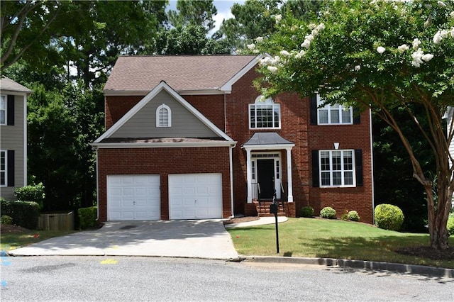 view of front of house with a front yard and a garage