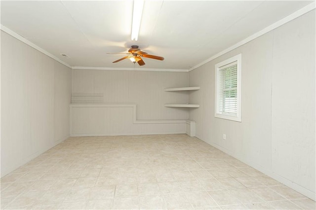 tiled empty room featuring ceiling fan and crown molding