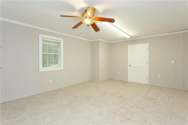 spare room with light tile floors, crown molding, and ceiling fan