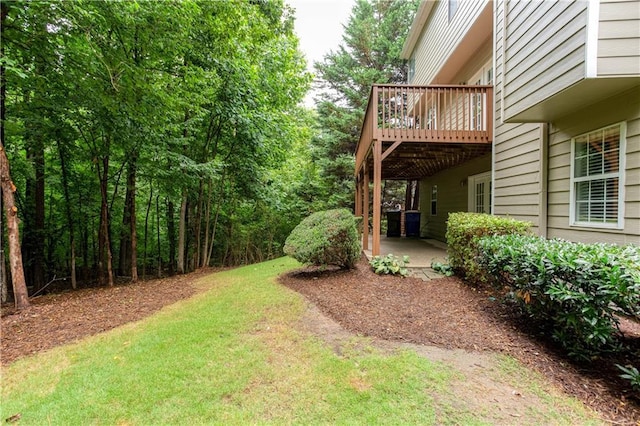 view of yard featuring a wooden deck and a patio area