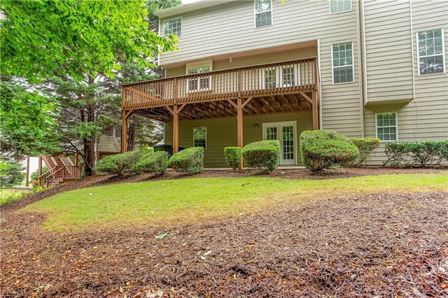 back of house featuring a deck and a lawn