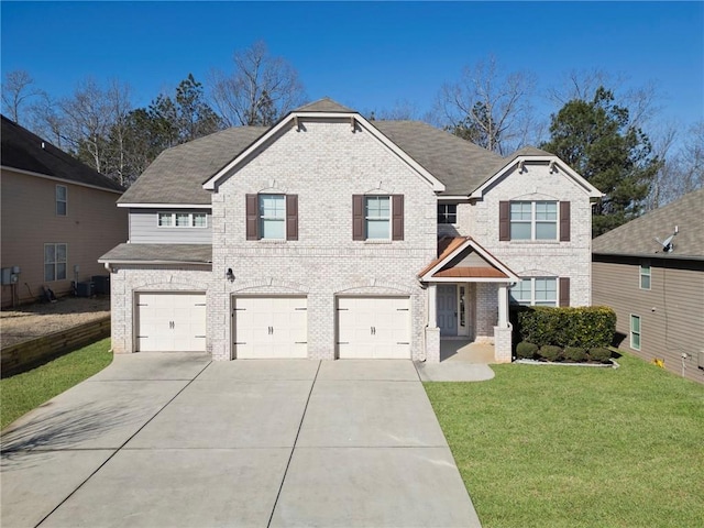 traditional-style home with brick siding, a front yard, roof with shingles, a garage, and driveway