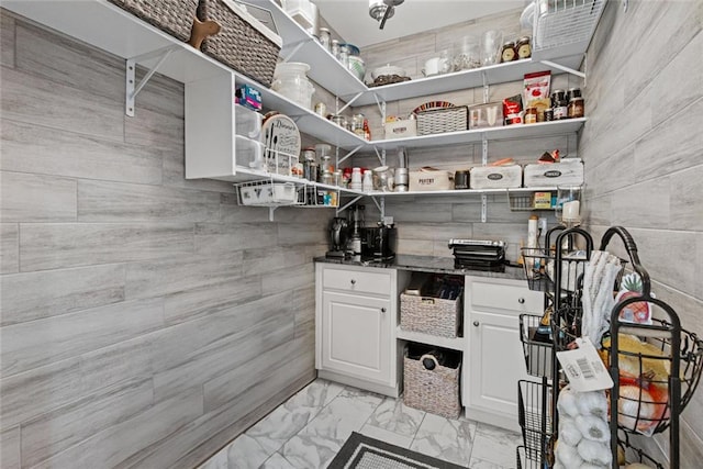 415 Southridge Rd, Winder, GA 30680 - kitchen with open shelves, light marble finish floors, white cabinets, and tile walls