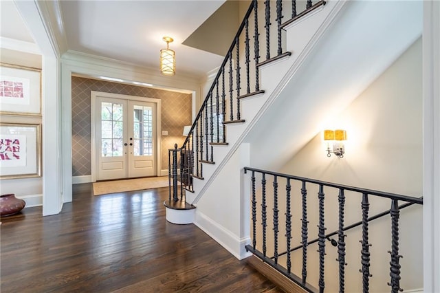 entrance foyer with wood finished floors, baseboards, stairs, french doors, and crown molding