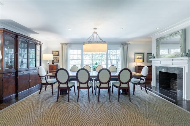 dining space featuring recessed lighting, a fireplace, crown molding, and wood finished floors