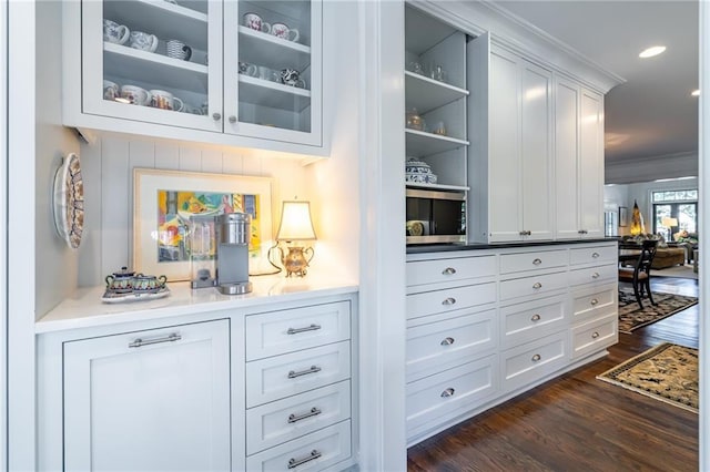 bar featuring dark wood-style floors, recessed lighting, and crown molding