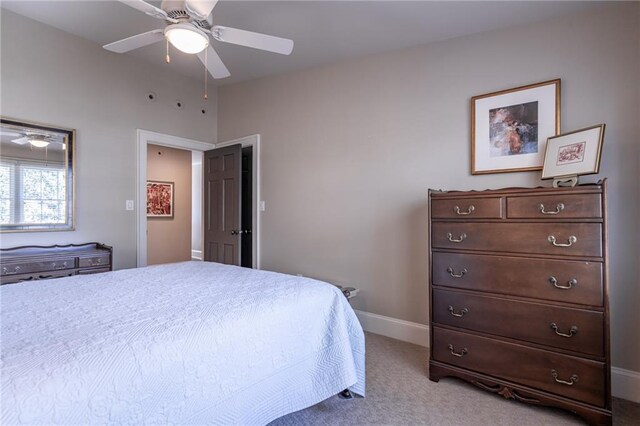 carpeted bedroom with baseboards and a ceiling fan