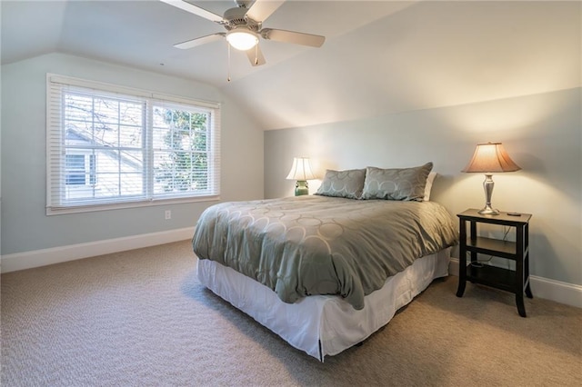 carpeted bedroom with baseboards, vaulted ceiling, and a ceiling fan