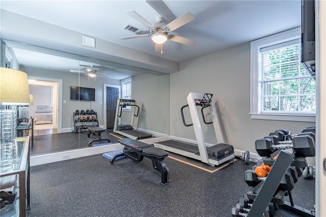 workout room with visible vents, baseboards, and a ceiling fan