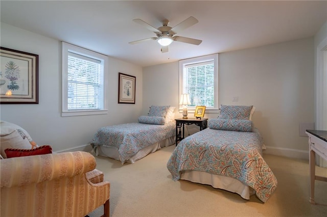 bedroom featuring multiple windows, carpet, a ceiling fan, and baseboards