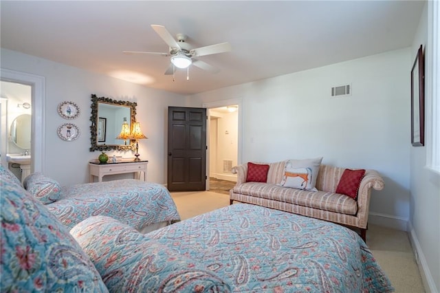 bedroom with a ceiling fan, ensuite bath, visible vents, and baseboards