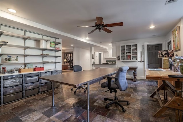 office with recessed lighting, stone finish floor, visible vents, and ceiling fan