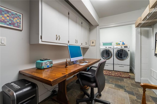 home office with washer and dryer and stone finish flooring