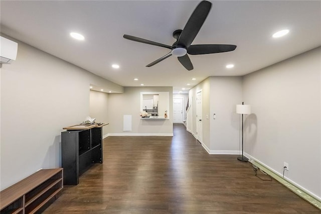 interior space featuring recessed lighting, baseboards, an AC wall unit, and dark wood-style floors