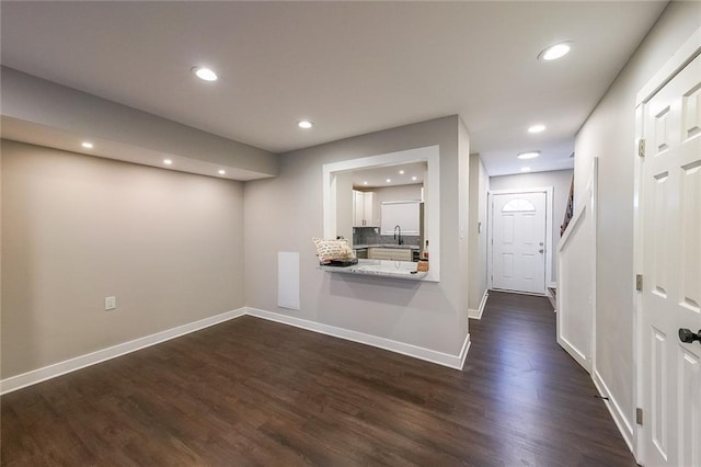 interior space with dark wood-type flooring, recessed lighting, and baseboards