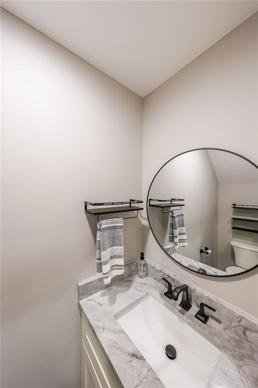 bathroom featuring toilet and vanity