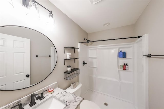 bathroom featuring a sink, toilet, and walk in shower