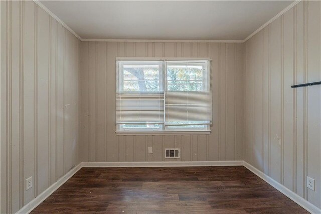 unfurnished room with crown molding and dark hardwood / wood-style flooring