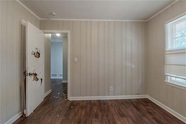 unfurnished room with crown molding and dark hardwood / wood-style flooring