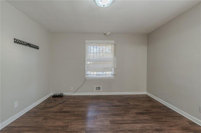 empty room featuring dark wood-type flooring