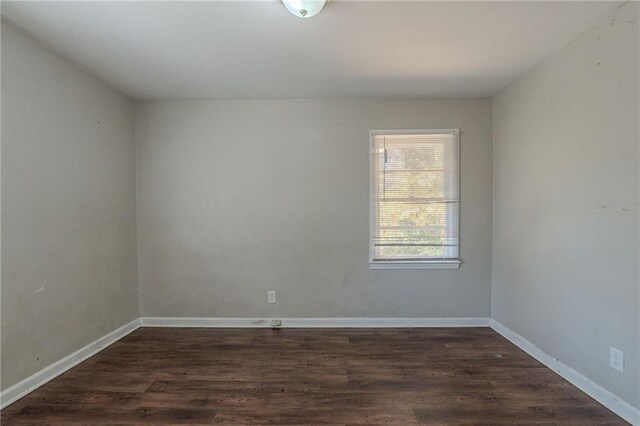 unfurnished room with dark hardwood / wood-style floors