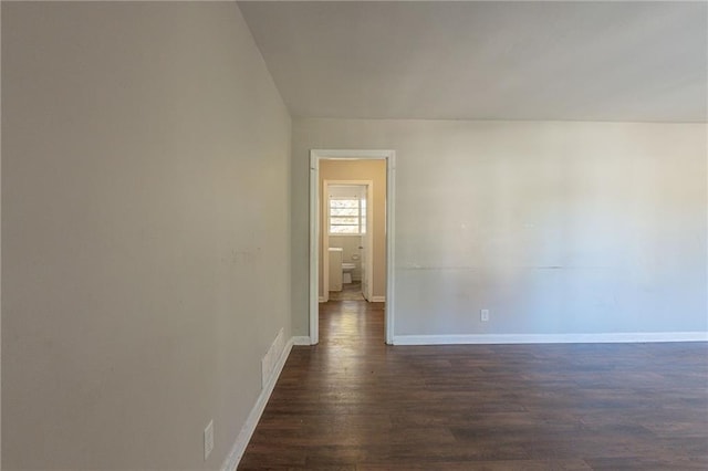 unfurnished room featuring dark wood-type flooring