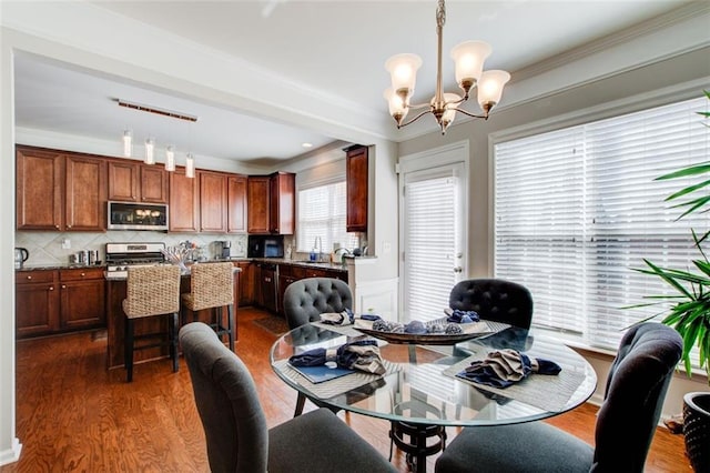 dining area featuring an inviting chandelier and dark wood-type flooring