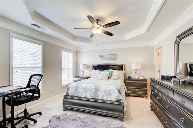 carpeted bedroom with crown molding, a tray ceiling, and ceiling fan