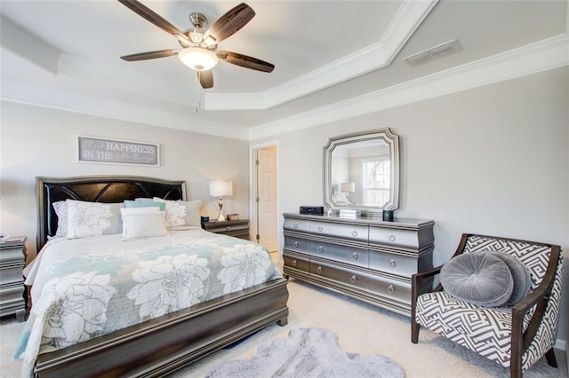 bedroom with light carpet, a tray ceiling, ornamental molding, and ceiling fan