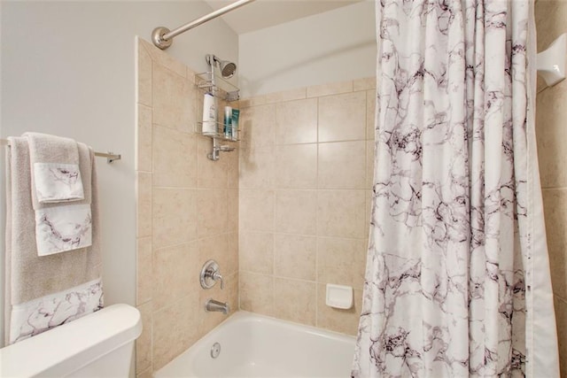 bathroom featuring toilet and shower / bathtub combination with curtain