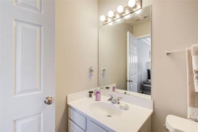 bathroom with vanity and toilet