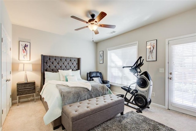 bedroom featuring access to outside, light colored carpet, and ceiling fan