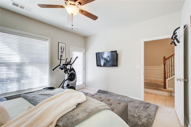 tiled bedroom featuring ceiling fan