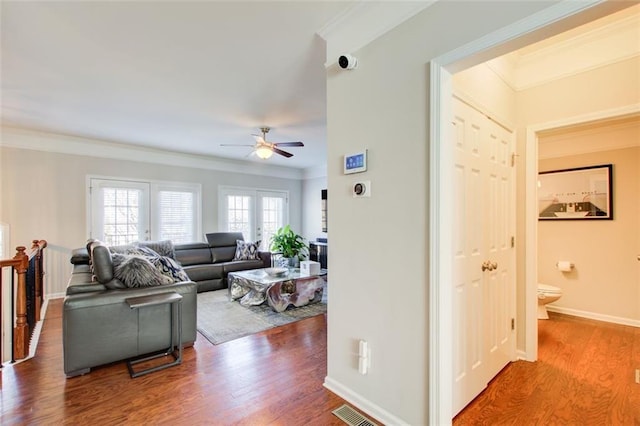 living room featuring ornamental molding, hardwood / wood-style floors, and ceiling fan