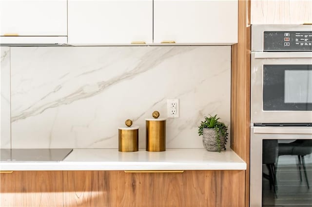 room details featuring white cabinets and double oven