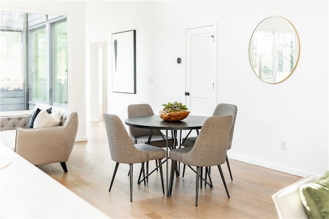 dining area with light hardwood / wood-style floors