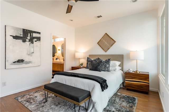 bedroom featuring ceiling fan, wood-type flooring, and ensuite bathroom