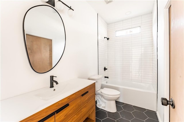 full bathroom with tile patterned floors, toilet, vanity, and tiled shower / bath