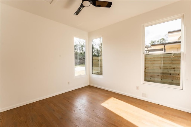 empty room featuring ceiling fan and hardwood / wood-style floors