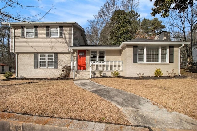 view of front of property with a front yard and a porch