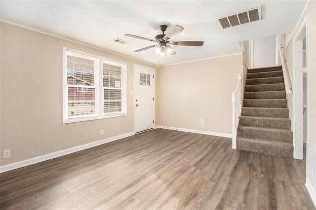 interior space featuring crown molding, dark wood-type flooring, and ceiling fan