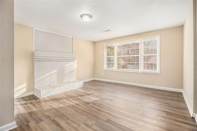 unfurnished living room with hardwood / wood-style floors