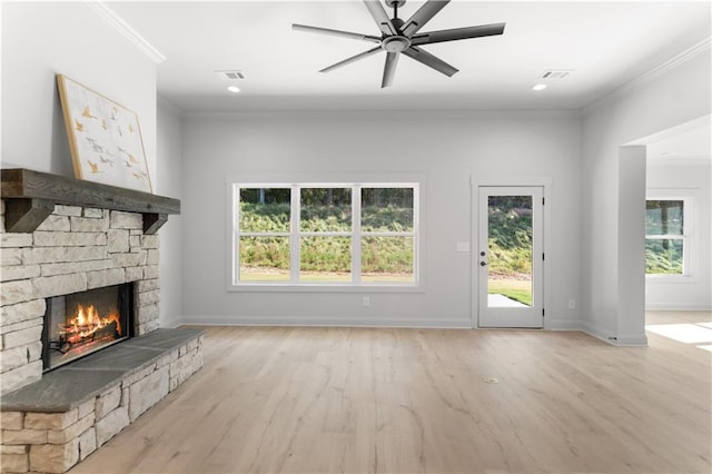 unfurnished living room featuring a stone fireplace, ceiling fan, light hardwood / wood-style flooring, and ornamental molding