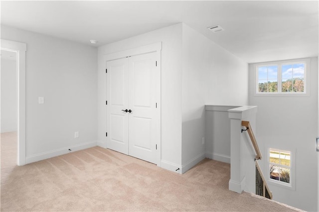 interior space featuring light carpet and a wealth of natural light