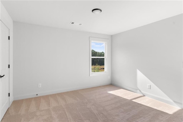 unfurnished room featuring light colored carpet