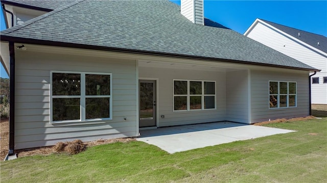 back of house with a patio area and a yard